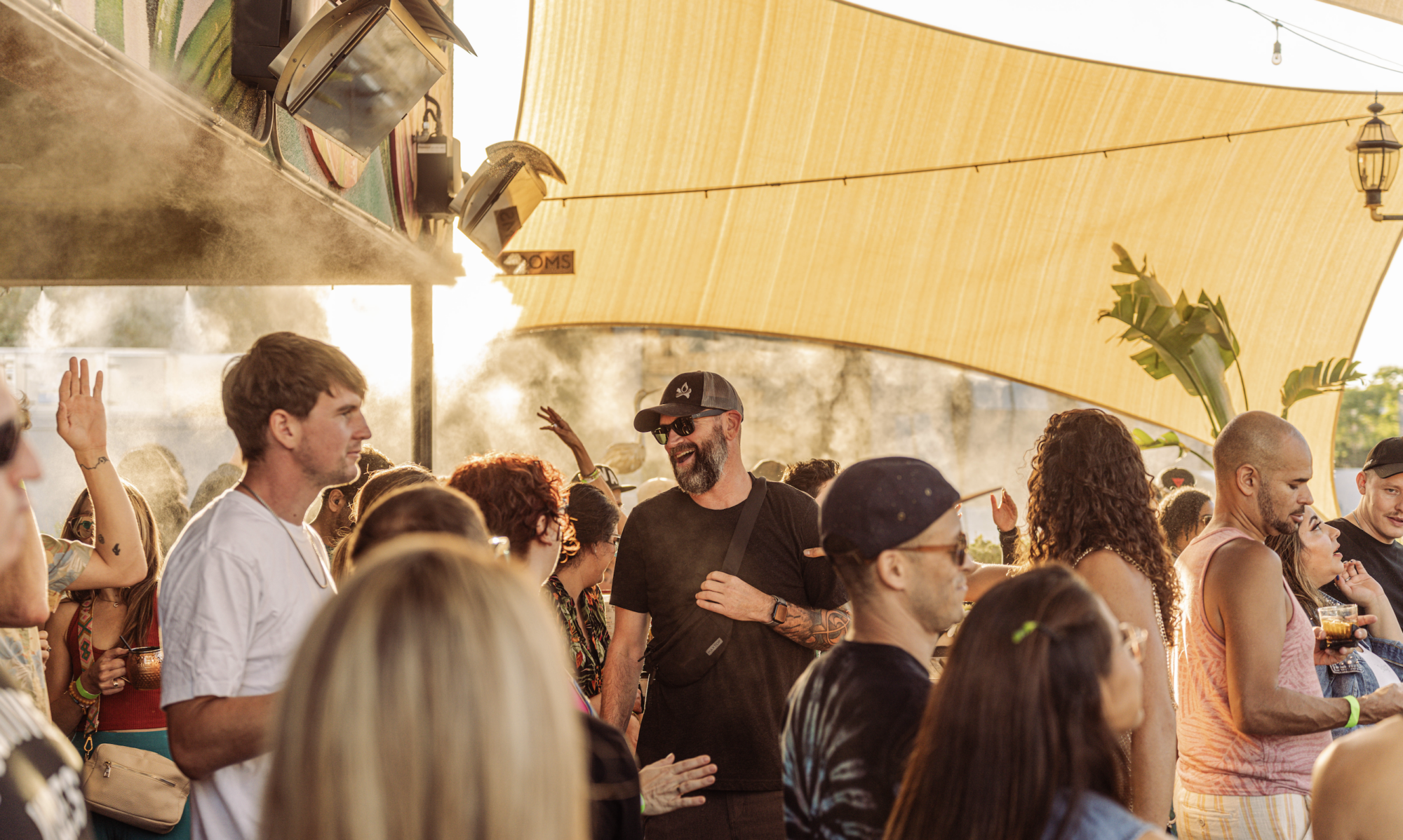 Guests having a great time on the rooftop of Darling Aviary in Downtown Sacramento, enjoying drinks, food, and stunning skyline views.